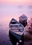 two boats sitting in the water on a lake