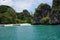 Two Boats on the Small, Secluded Beach of the Trees Covered Island