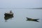 Two boats were floating in the river in an afternoon.