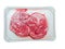 Two boneless lamb leg steaks on a plastic tray. Uncooked high quality meat product with rich taste and vivid color. White