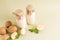 Two bottles of environmentally friendly potato milk from all types of plant-based milk on a beige background with potato tubers