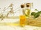 Two bottles of oil, skin care, aromatherapy, stand on a wooden stand, dried flowers