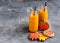 Two bottles of pumpkin juice with black straws Horizontal photo Halloween food and sweets