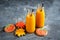Two bottles of pumpkin juice with black straws Horizontal photo Halloween food and sweets concept