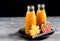 Two bottles of pumpkin juice with black straws Horizontal photo Halloween food and sweets Copy space