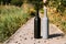 Two bottles stand on a rural road, private vineyards. natural drink. wine