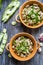 Two bowl with broad beans, parsley and garlic