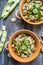 Two bowl with broad beans, parsley and garlic