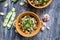 Two bowl with broad beans, parsley and garlic