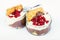 Two bowl with vanilla and pomegranate mousse on white background.