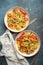 Two bowls with Chow Mein or Lo Mein, traditional Chinese stir fry noodles with meat and vegetables, served with