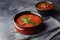 Two bowls with different types of homemade gazpacho with copy space.