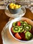 Two bowls of fruit on white stands