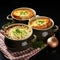 Two bowls hold a savory treasure French onion soup with melted cheese