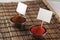 Two bowls of spices with price stickers