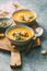 Two bowls of warm pumpkin soup with croutons and spices.