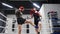 Two boxer man training kick by legs on boxing ring. Low angle view. Boxer man training together personal trainer in gym