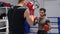 Two boxer man training together on boxing ring in fight club. Fighter man training fight in boxing gloves while sparring