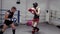 Two boxers training high kick on ring in fight club. Personal coach showing kick exercise to fighter on boxing ring.