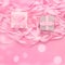 Two boxes with gifts on the background of a Coil of decorative satin ribbons of pink color.