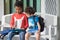 Two boy kid sitting on bench and playing game on tablet at preschoo,Kindergarten school education concept.diversity children.