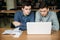 Two boy student use laptop in library. They use laptop to prepare for an exam. Study