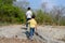 Two Boy walking on the rocky land.