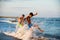 Two boys adolescence playing in the sea water splashing feet wat