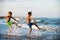 Two boys adolescence playing in the sea water splashing feet water