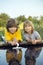 Two boys allowed paper boats from the pier of river