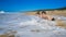 Two boys on the beach getting wet by the wave