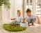 Two boys brothers plaing with wooden cube blocks on knitted grass carpet on the floor indoor. Knitted style in the interior: