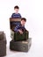 Two boys, brothers, playing with boxes on white background
