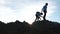 Two boys, brothers, are walking along the mountain on a journey.