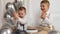 Two boys celebrating birthday, children applauding. Birthday cake with candles and balloons. Happy kids, celebration