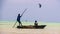 Two boys on Dhow with kite surfer in background