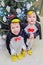 Two boys dressed as penguin standing near