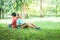 Two boys in elementary school, international school, reading in the garden