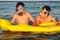 Two boys enjoy their time on the beach