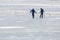 Two boys on a frozen lake frightened by a melted puddle in the weak ice, dangerous recreational fun in thawing weather, copy space