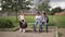 Two boys and girl use their phones during school breack. Cute boys sitting on the bench and play online games