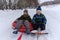 Two boys go snow sledding and tubing