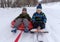 Two boys go snow sledding and tubing