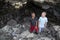 Two boys having fun hiking and exploring in some Lava rock caves