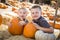 Two Boys Having Fun at the Pumpkin Patch on a Fall Day