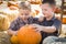 Two Boys Having Fun at the Pumpkin Patch on a Fall Day