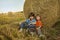 Two boys in a haystack in the field