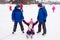 Two boys helps girl learn to skate