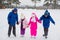 Two boys helps girls learn to skate