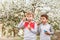 Two boys inflate soap bubbles in the summer outdoors